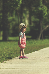 Image showing little girl runing in the summer Park