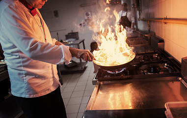 Image showing Chef doing flambe on food