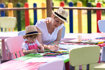 Image showing mom and little daughter drawing a colorful pictures