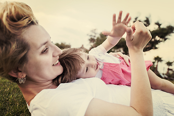 Image showing mother and little daughter playing at backyard