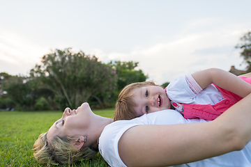 Image showing mother and little daughter playing at backyard