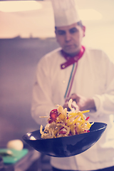 Image showing chef flipping vegetables in wok