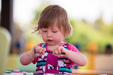 Image showing little girl drawing a colorful pictures