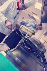 Image showing chef preparing food, frying in wok pan