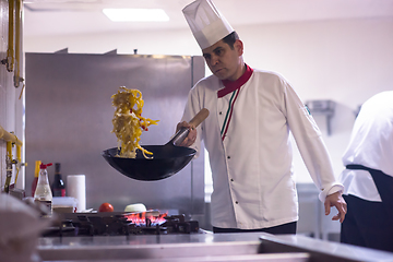 Image showing chef flipping vegetables in wok