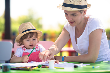 Image showing mom and little daughter drawing a colorful pictures