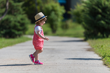 Image showing little girl runing in the summer Park