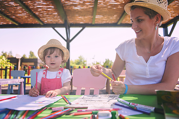 Image showing mom and little daughter drawing a colorful pictures