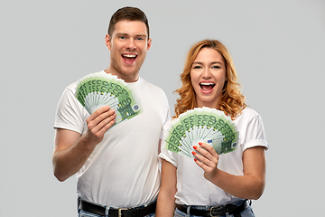 Image showing happy couple in white t-shirts with euro money