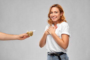 Image showing happy couple in white t-shirts with christmas gift