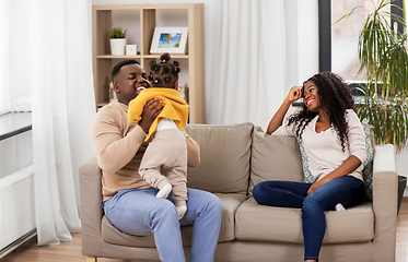 Image showing african family playing with baby daughter at home