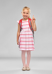 Image showing little girl with school bag pointing finger up