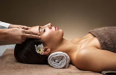 Image showing woman having face and head massage at spa