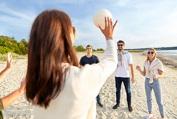 Image showing friends playing volleyball on beach in summer