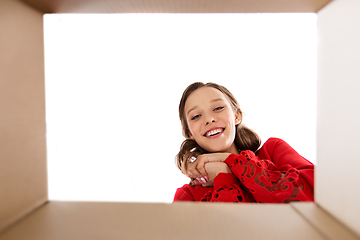 Image showing happy young woman looking into open gift box