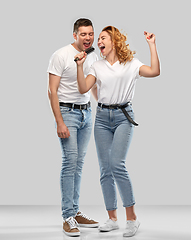 Image showing happy couple singing to hairbrush