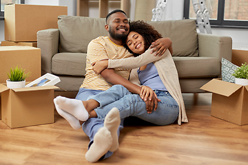 Image showing happy couple with boxes moving to new home