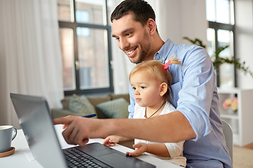 Image showing working father with baby daughter at home office