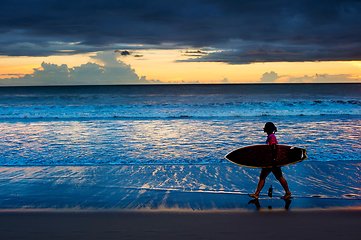 Image showing Woman surfer at sunset. Bali