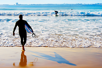 Image showing Surfer going to surf