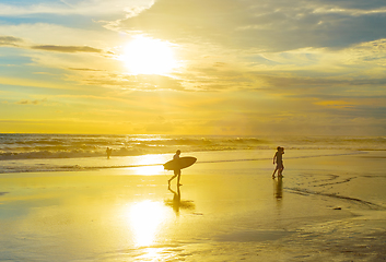 Image showing Surfer with surfboard, tropical beach