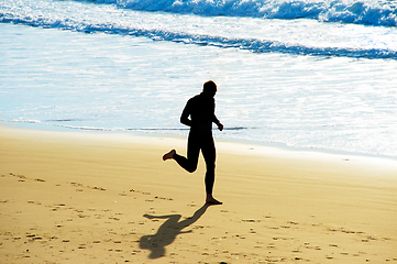 Image showing Man jogging on a beach