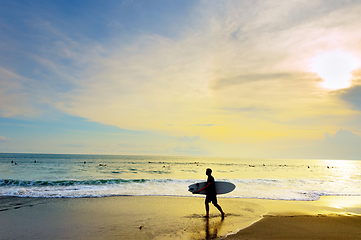 Image showing Surfer with surfboard beach. Bali