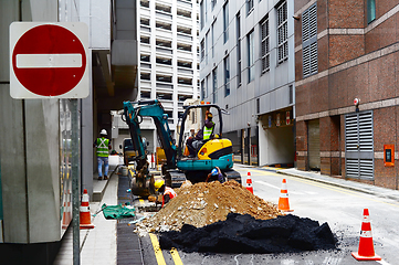 Image showing Singapore road workers fixing problem