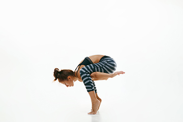 Image showing Sporty young woman doing yoga practice isolated on white background