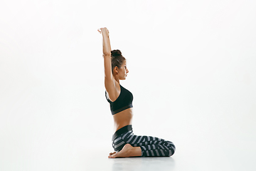 Image showing Sporty young woman doing yoga practice isolated on white background