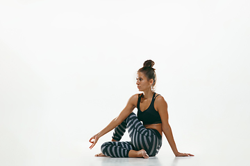 Image showing Sporty young woman doing yoga practice isolated on white background