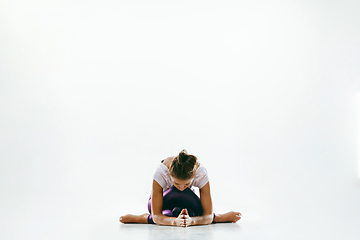 Image showing Sporty young woman doing yoga practice isolated on white background