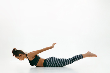 Image showing Sporty young woman doing yoga practice isolated on white background