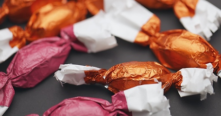 Image showing Christmas candy lying on the table with camera in motion closeup