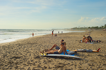 Image showing Surfers relaxing on the beach