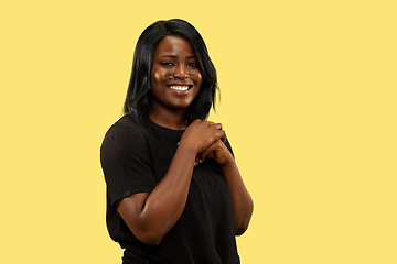 Image showing Young african woman isolated on yellow studio background, facial expression