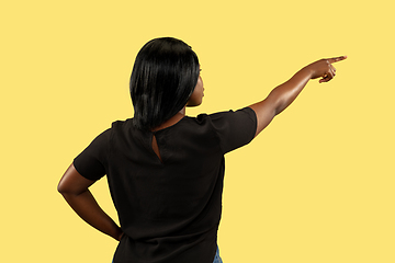 Image showing Young african woman isolated on yellow studio background, facial expression