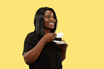 Image showing Young african woman isolated on yellow studio background, facial expression