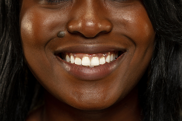 Image showing Young african woman isolated on yellow studio background, facial expression