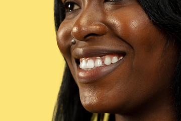 Image showing Young african woman isolated on yellow studio background, facial expression