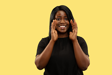 Image showing Young african woman isolated on yellow studio background, facial expression