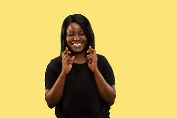 Image showing Young african woman isolated on yellow studio background, facial expression