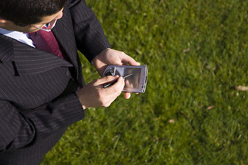 Image showing businessman working with a palmtop