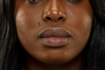 Image showing Young african woman isolated on yellow studio background, facial expression