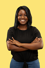 Image showing Young african woman isolated on yellow studio background, facial expression