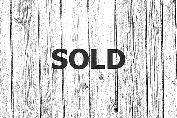 Image showing Text Sold. Business concept . Wooden texture background. Black and white