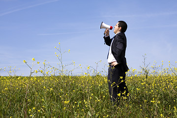 Image showing Businessman speaking with a megaphone