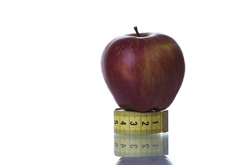 Image showing Red apple over a measure tape