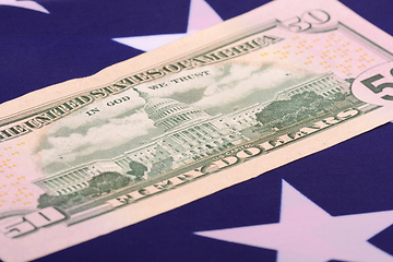 Image showing fifty dollar bill in front of the American flag