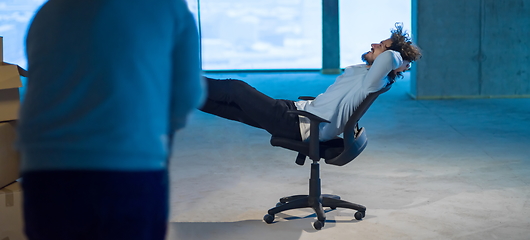 Image showing young business man taking a break on construction site